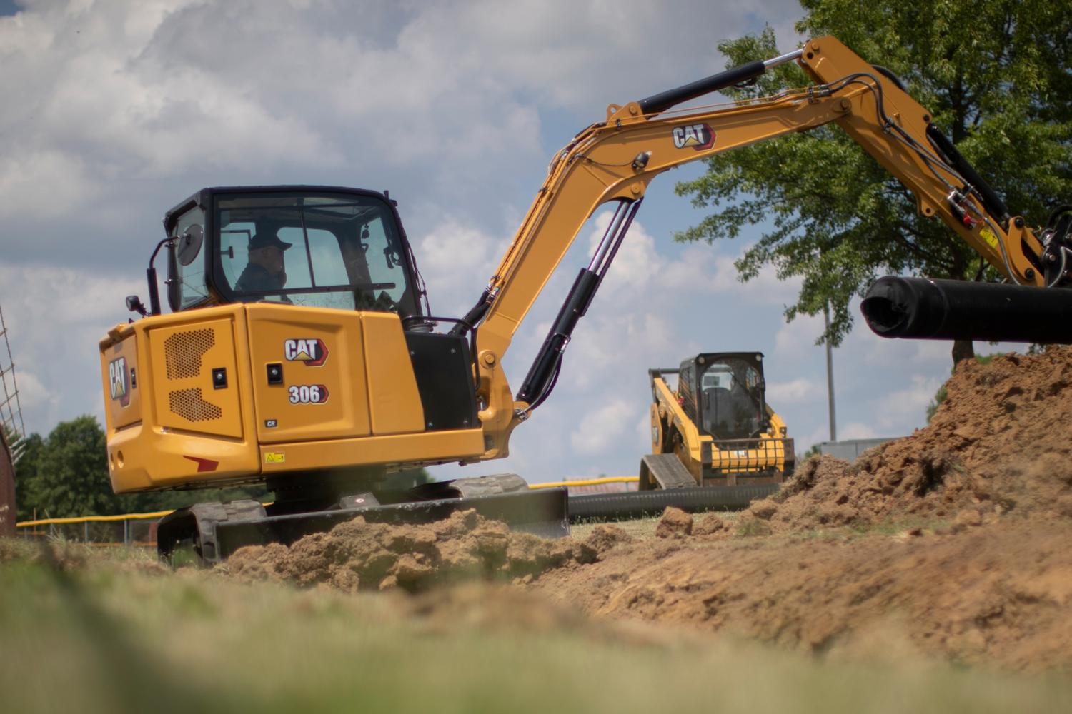 A medium CAT excavator working at a job site