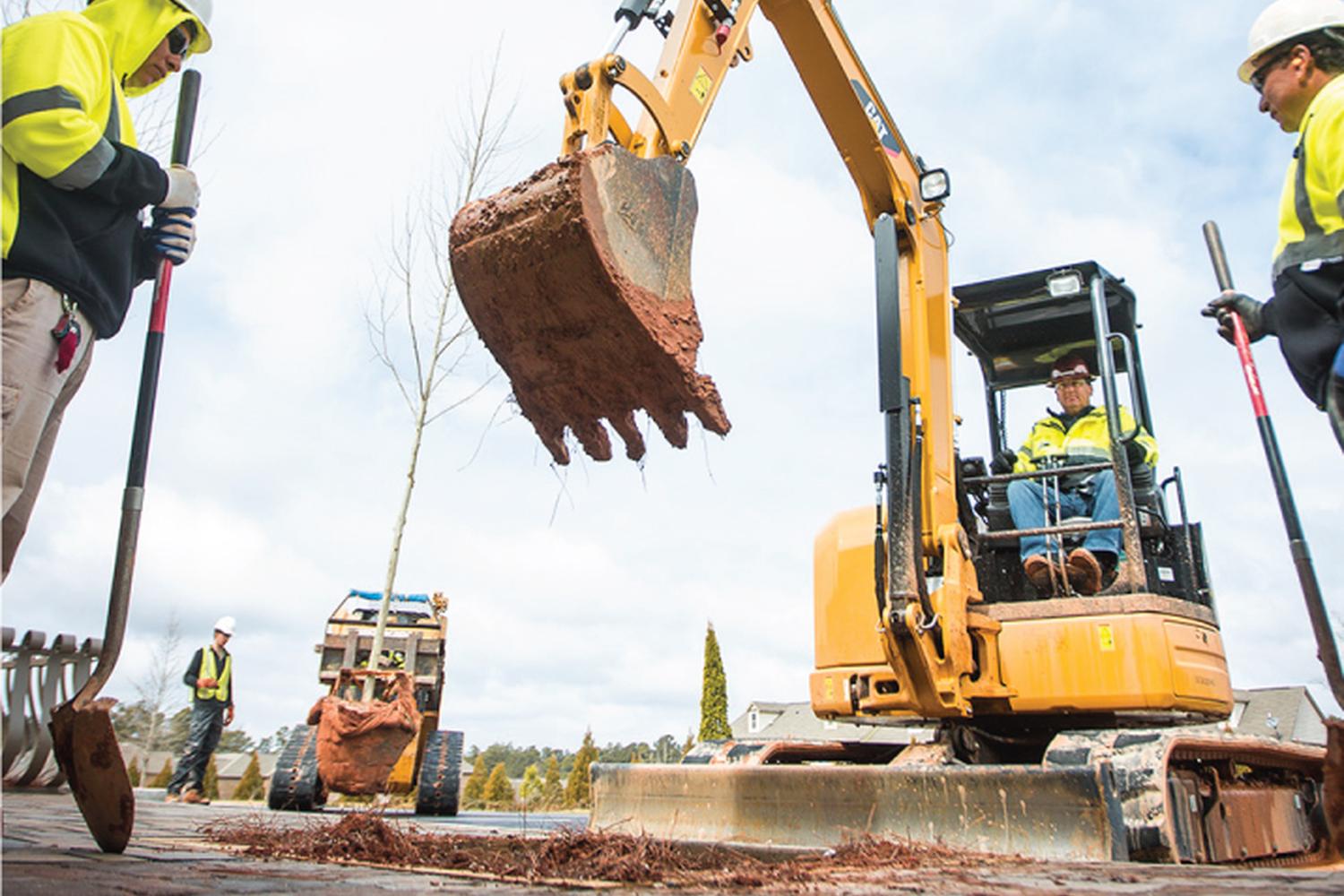 Small CAT excavator digging at a rental job site