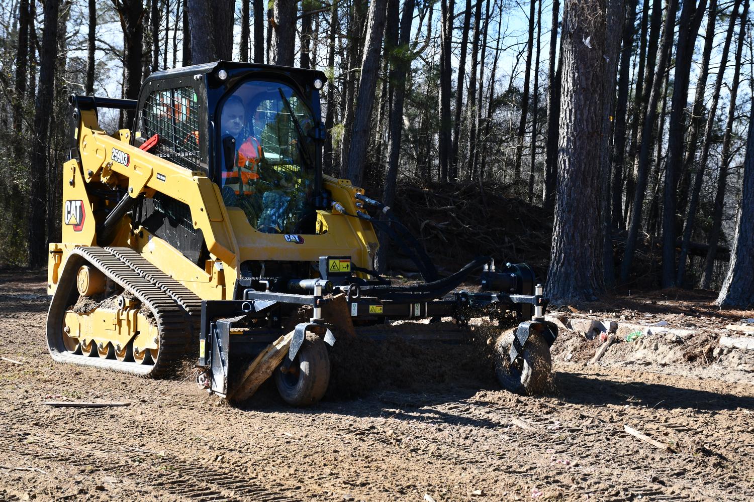 Rented CAT skid working in woods
