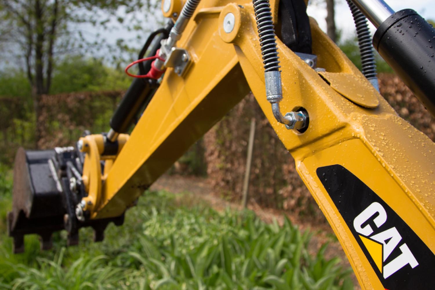 Arm of a rented CAT landscaping machine
