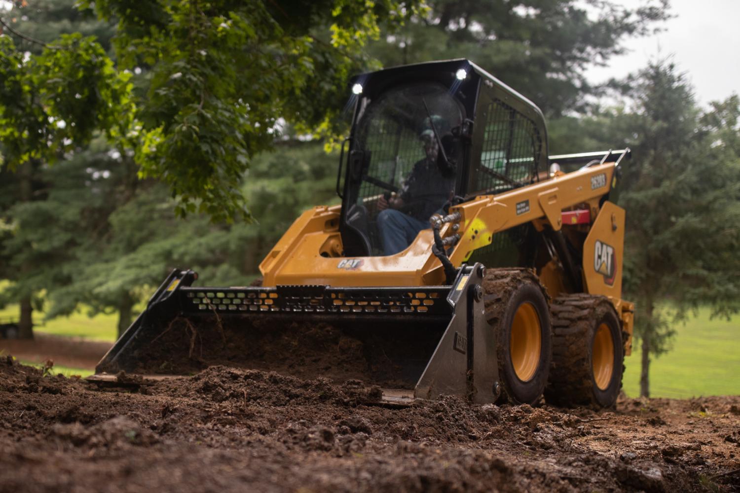 CAT rentable skid steer moving dirt at a job site