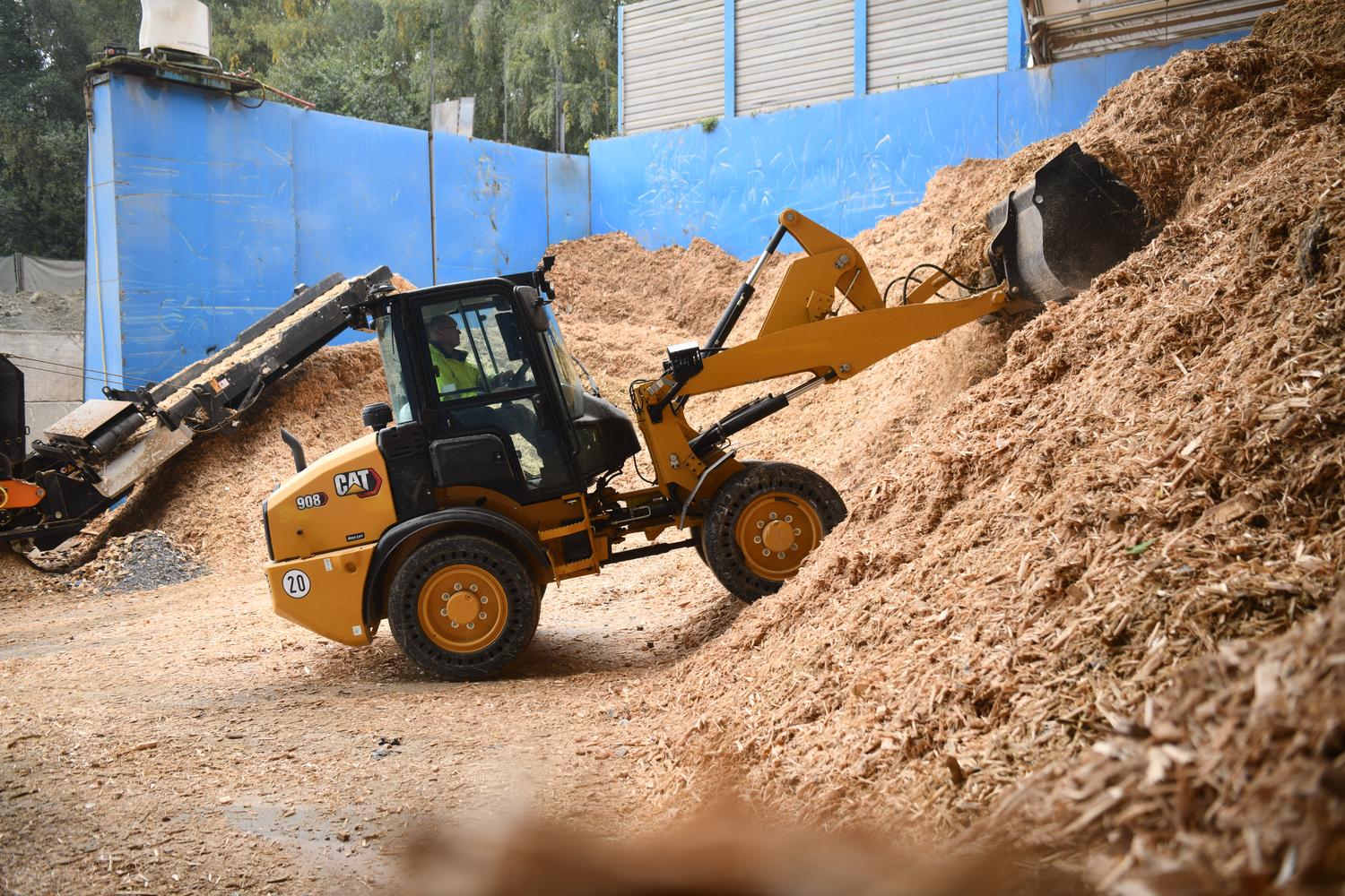 Small rented CAT loader while loading dirt